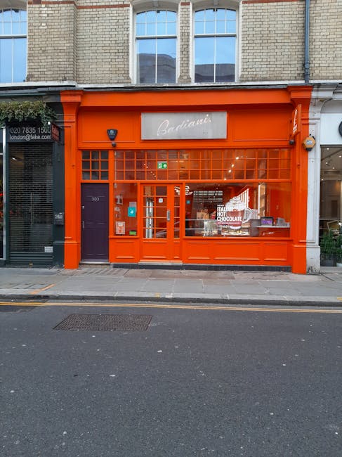 Exterior view of South Harrow Food Centre on St Anns Road Harringay, showing a brick building with a red and white signage displaying options like burger, Turkish, Afghan, Asian, and bakery. The store